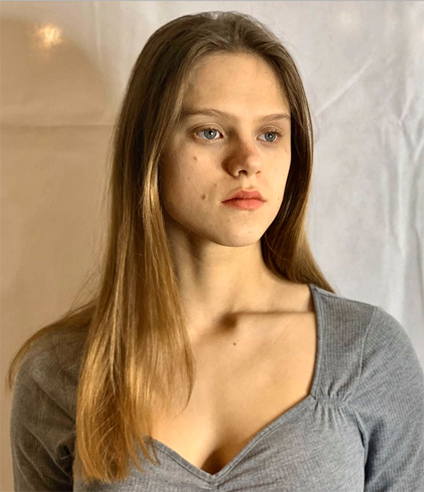 Photograph of Tabitha Home wearing a grey top shot against a white background.